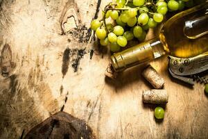 White wine with a bunch of grapes. photo