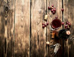 Red wine with grapes photo