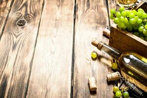 White wine with a box full of grapes. photo