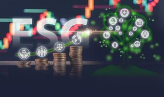 ESG concept, a tree hologram grows from a pile of coins on a stock market graph, representing the growth of sustainable businesses in the global economy. photo