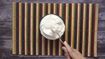 fresh yogurt in a bowl on table . video