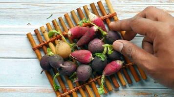 hand pick radish bundle on table video