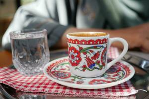 a cup of turkish coffee on table photo