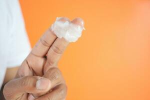 Close up of man hand using petroleum jelly photo