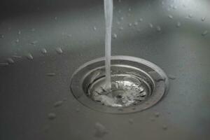 water pouring from a faucet tap slow motion photo