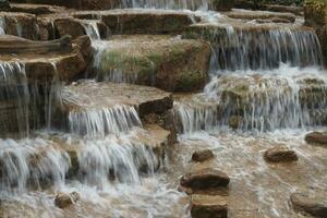 slow motion of Waterfall In a natural park singapore photo