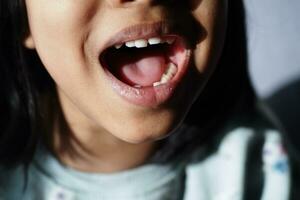 close up of child screaming at home photo