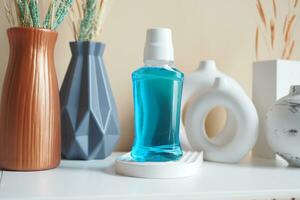 mouthwash liquid in a container on table photo