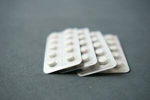 Close up of pills of blister pack on table photo