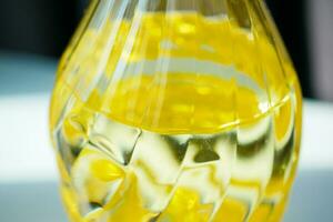 yellow sunflower oil bottle on table photo