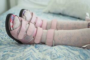 Child cerebral palsy disability, legs orthosis. photo