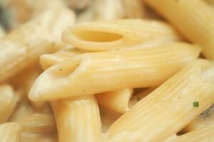 homemade cooked pasta in a plate on table . photo