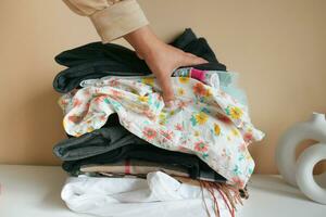 Stack of clothes on table indoor. photo