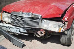 rojo coche dañado por un la carretera accidente foto