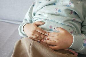 child suffering stomach pain close up. photo