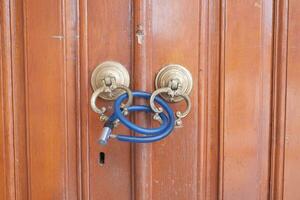 Closed old rusty lock on a wooden door photo