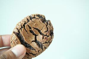 hand holding a chocolate sweet cookies photo