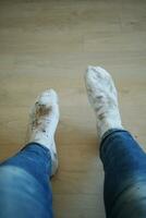 men feet with dirty socks while sitting on sofa photo