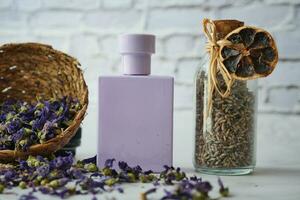 A studio photo of lavender flower and perfume on table