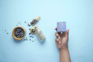 Homemade natural soap bar and lavender flower on purple background photo