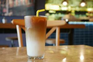 cold coffee in a glass container at cafe photo