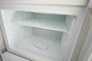 open empty fridge at home photo