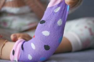 a colorful soft socks on child feet . photo