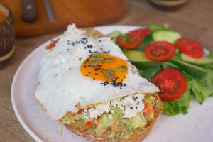 Tasty fresh toast with avocado and egg photo