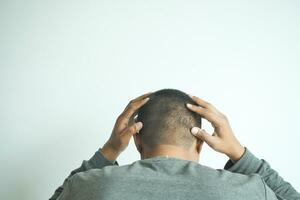 hair loss concept with man checking his hair with copy space photo