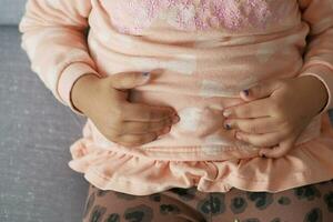 child suffering stomach pain close up. photo