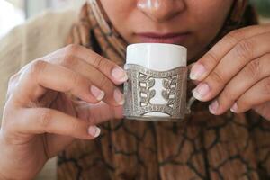 women holding a coffee cup photo