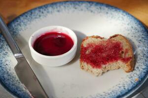 Spreading jam on on slice bread. photo