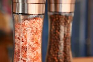 Raw dried pink Himalayan salt in glass vial photo