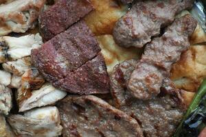 Kebab, traditional turkish meat food with salad on a plate . photo