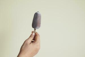 person hand holding ice cream with copy space photo