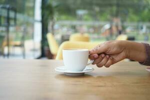 women holding a coffee cup against cafe background photo