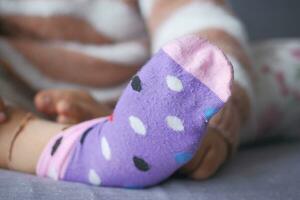 a colorful soft socks on child feet . photo