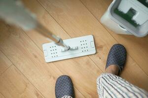 cleaning tiles floor with mop photo