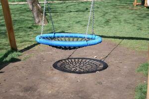 Close-up of a baby swing in the playground photo