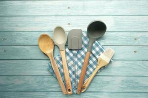 wooden cutlery forks and spoon on table cloth on blue table photo