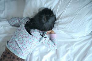 a child sleeping on bed photo