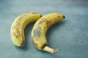 comparing rotten banana with a ripe banana on a white background photo
