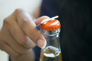 Metal cap and opener on the glass bottle photo