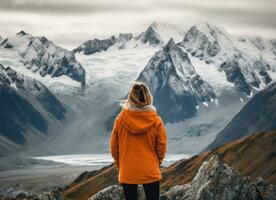 Back view of a female hiker looking at the mountain. AI Generated photo