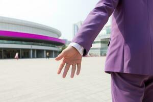 Executive in Purple Suit Walking in Hand with Colleague photo