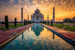 the stunning Taj Mahal, a majestic palace with minarets and a large reflecting pool, as the sun sets behind it. The breathtaking architecture and tranquil ambiance make for an unforgettable scene. photo