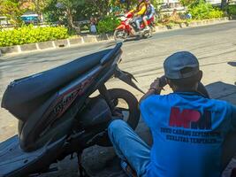 a tire repairman is fixing a punctured motorcycle tire photo