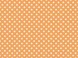 white polka dots over sandy brown background photo