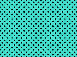 black polka dots over turquoise background photo