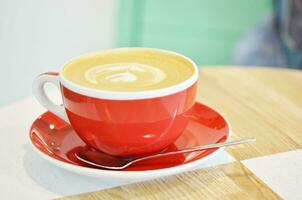 cup of coffee on table in coffee shop photo